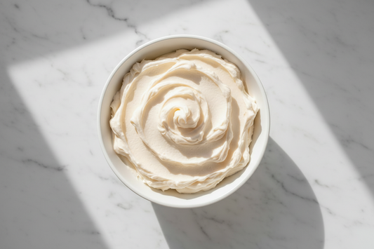 Bowl of whipped ivory body butter with creamy texture, safe for use during pregnancy
